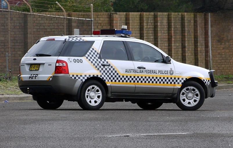 an suv in checkerboard driving down the street