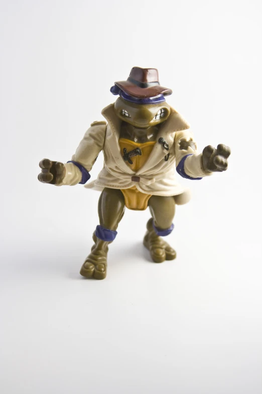 a plastic figure of a monkey that is wearing a top hat and suit