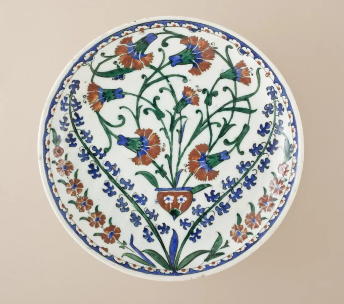 a decorative plate with flowers painted on it