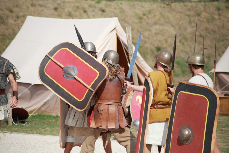 the men are wearing large armor and standing together