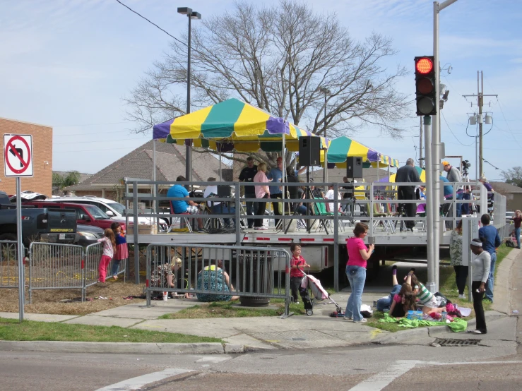 several people on an area near some trees and houses