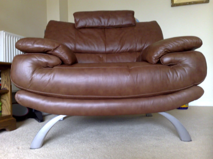 brown leather chair sitting in a living room