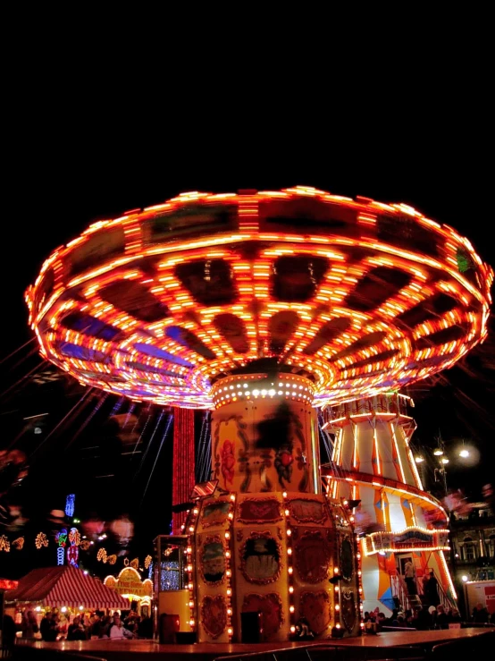a carnival rides with lights at night time