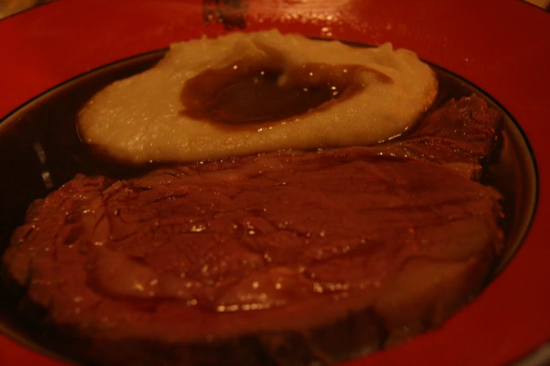 a piece of steak is being fried with gravy