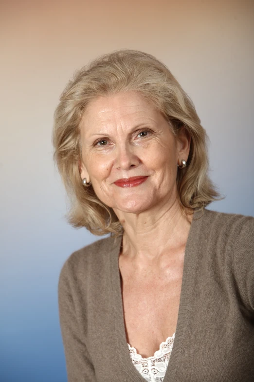 a woman with short blonde hair in brown shirt and white shirt