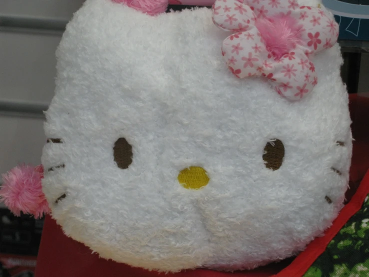 hello kitty stuffed animal with a red bow on its head