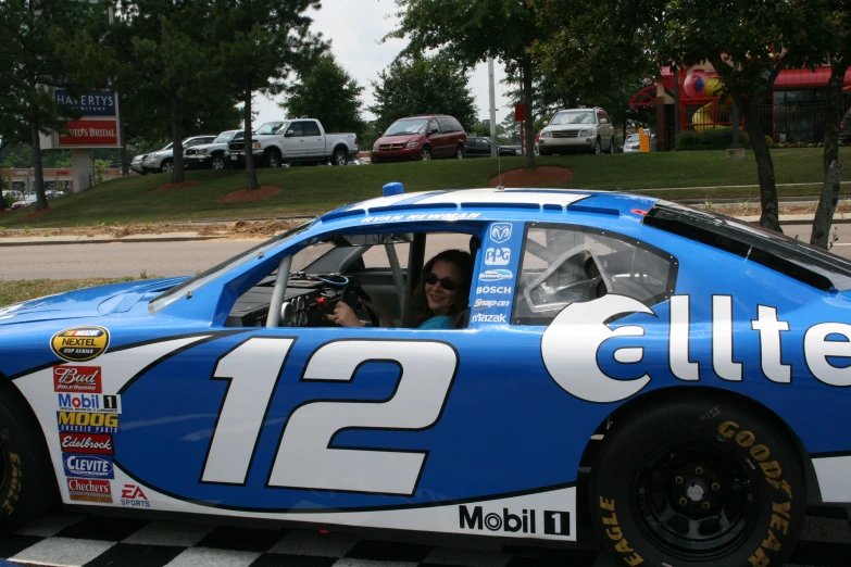 a driver in his racing car with the number 12 delta on