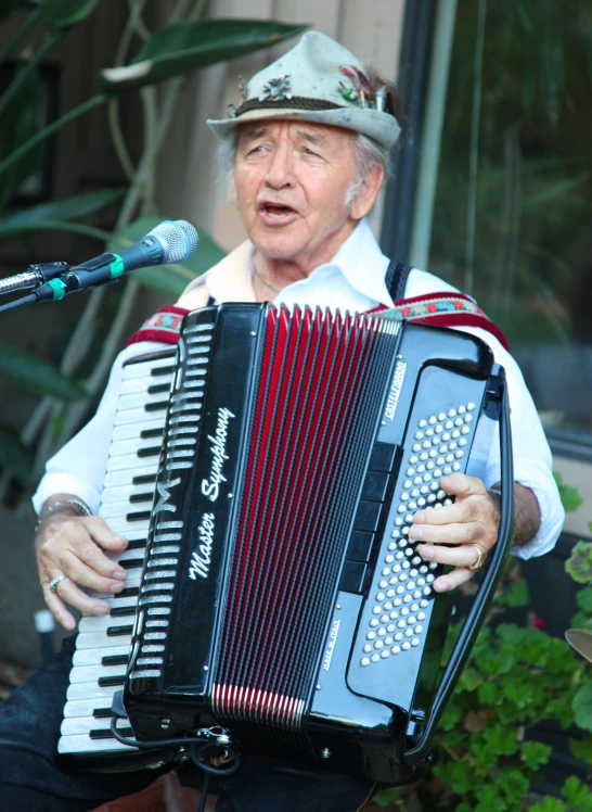 a person with an accordion in his hand while singing