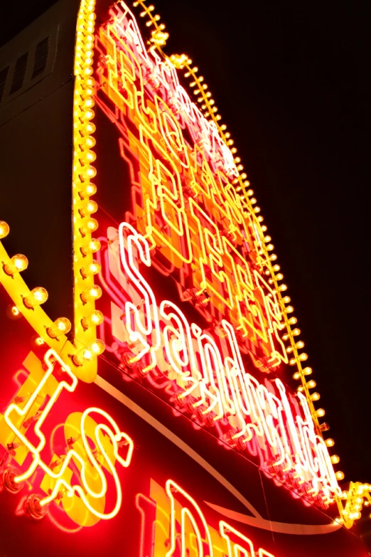 the neon sign shows the name of the business