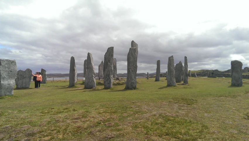 person standing amongst the large rocks at the end of a field