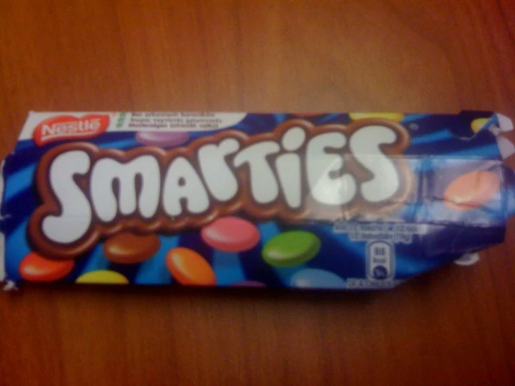 an empty box of smarties on a table