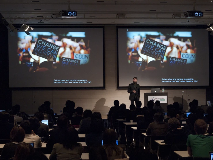 an audience looks at a projected screen in a classroom