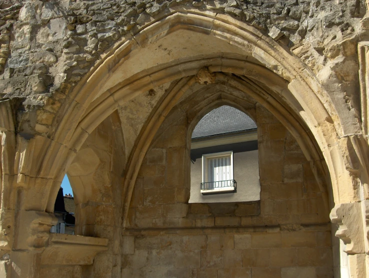 an arch doorway leading into a courtyard with a window