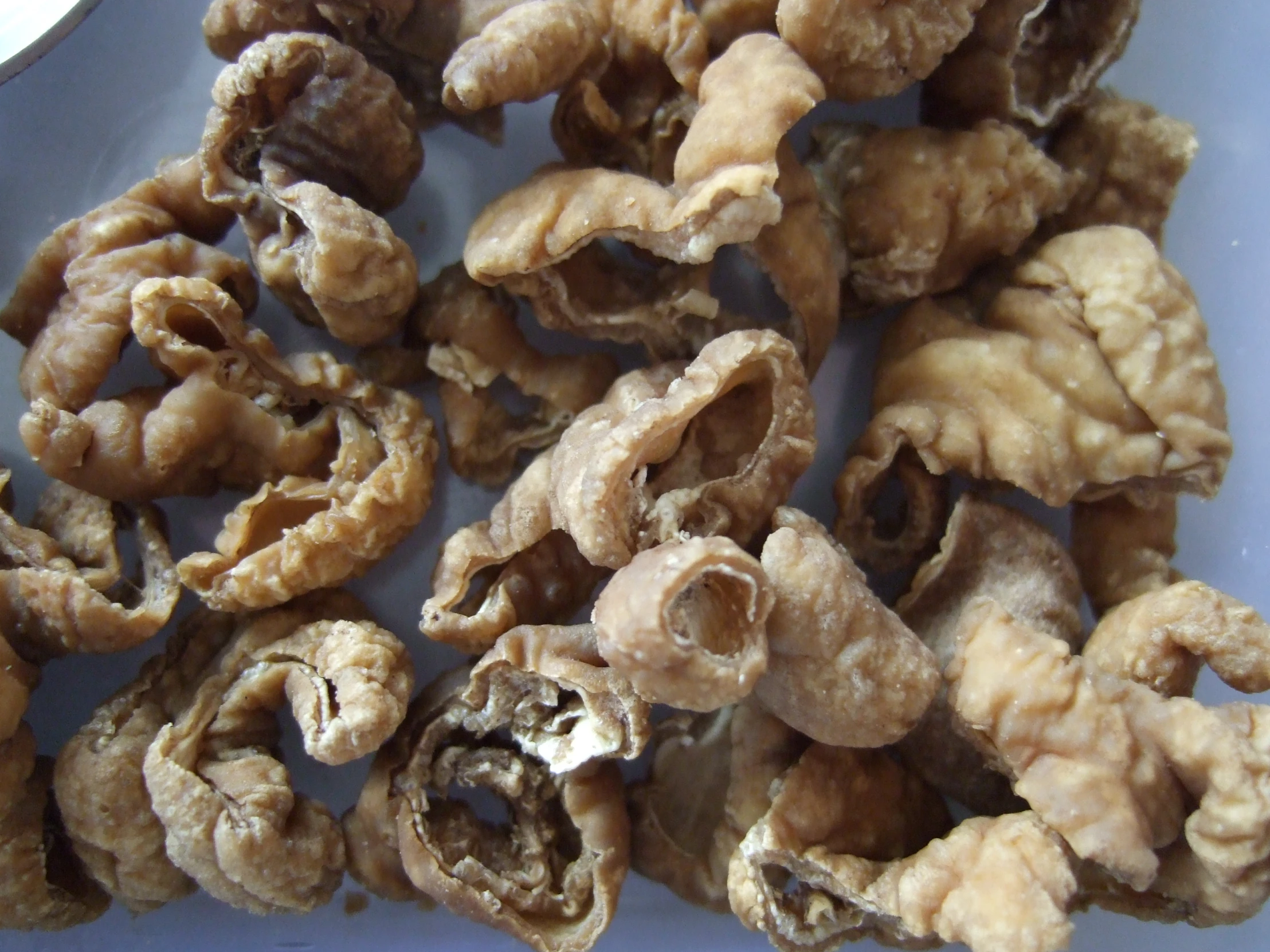 a pile of walnut nuts sitting on top of a table