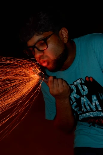 an image of a man that is  soing with sparks