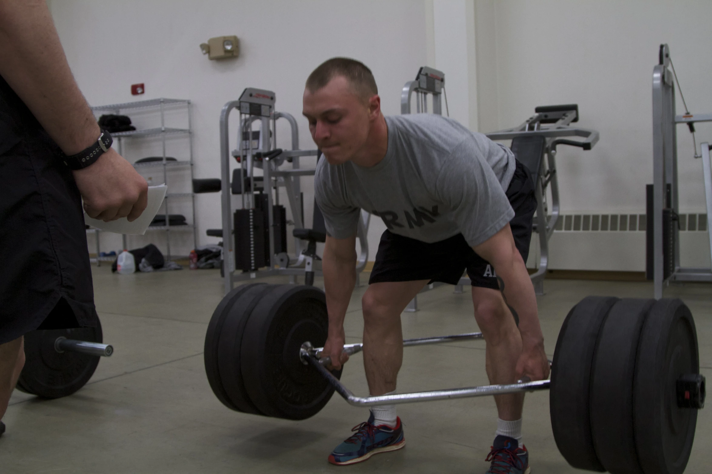 a man lifting heavy weight on the floor