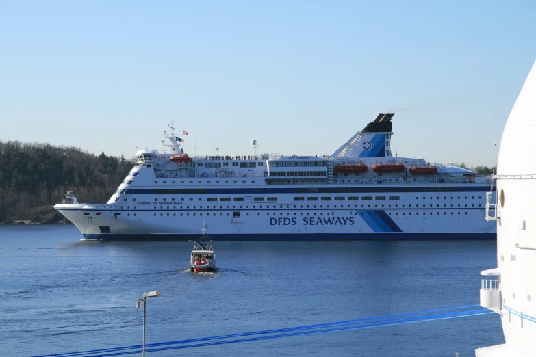 the large boat is moored to the dock in the water