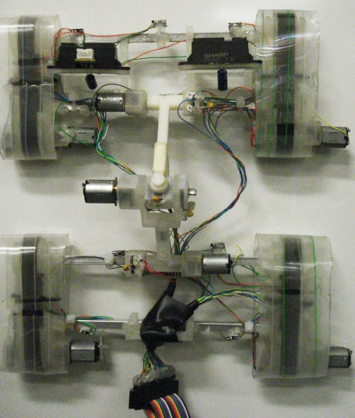 four electronic sculptons with wires and wire attached to them