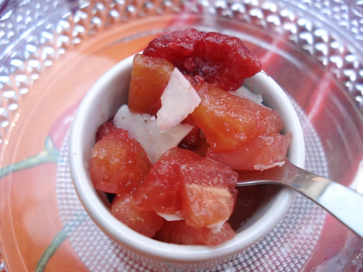 pieces of fruit are in a bowl on an orange plate