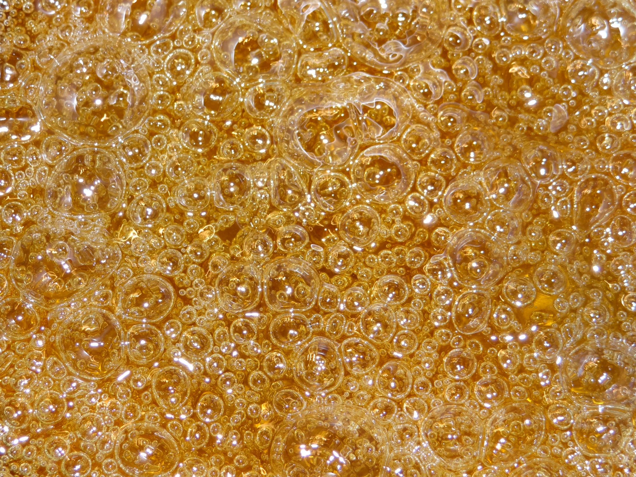 a mixture of water beads that are golden yellow and brown