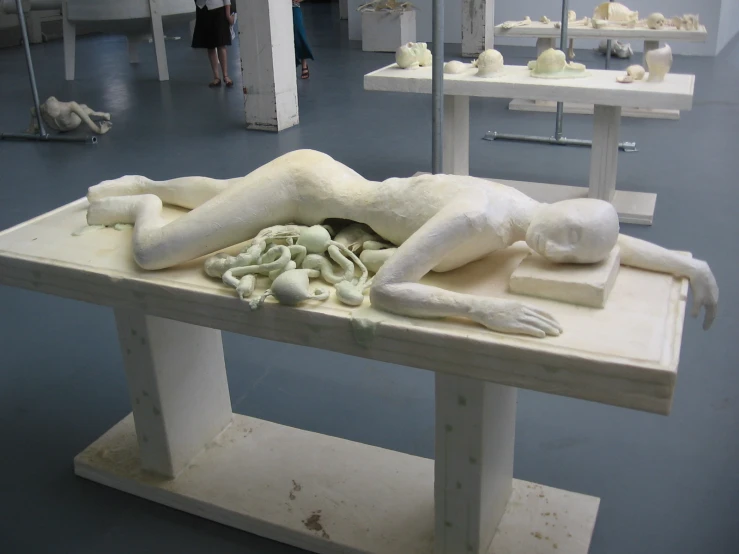 there is a large white sculpture of a woman on display