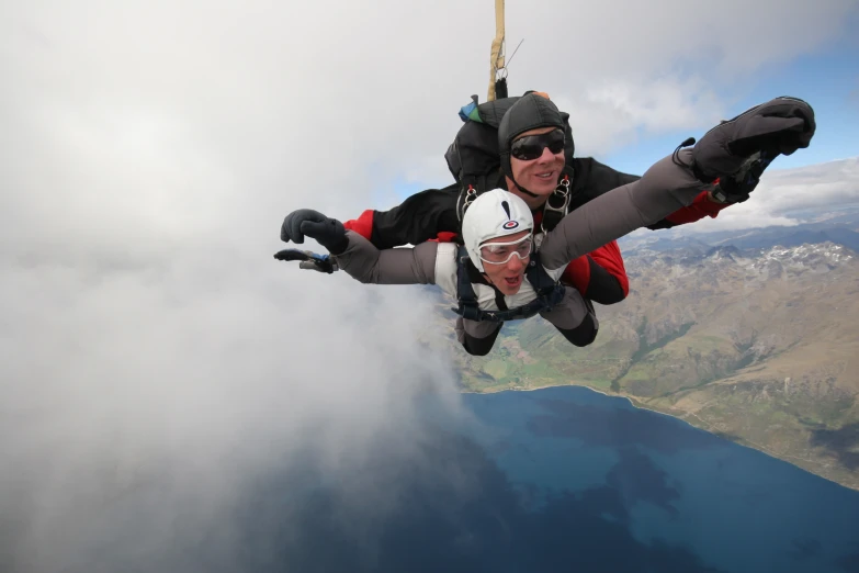 a man flying through the air while riding a parachute