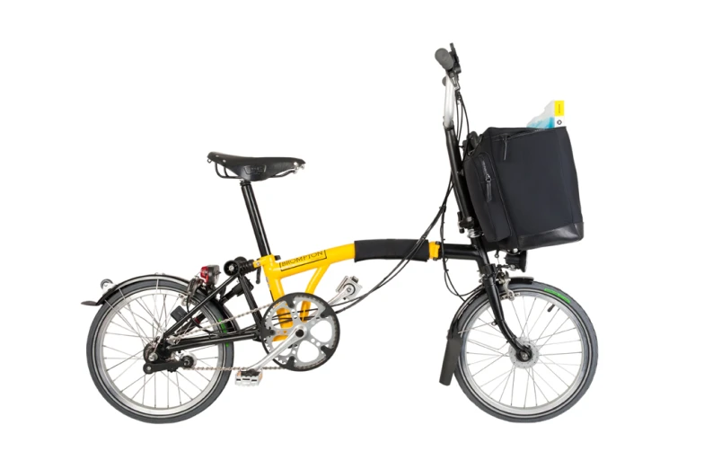 a bicycle with a basket on the side and a bag on the back