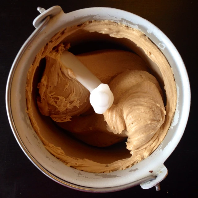 a close up of a bowl with a white mixer