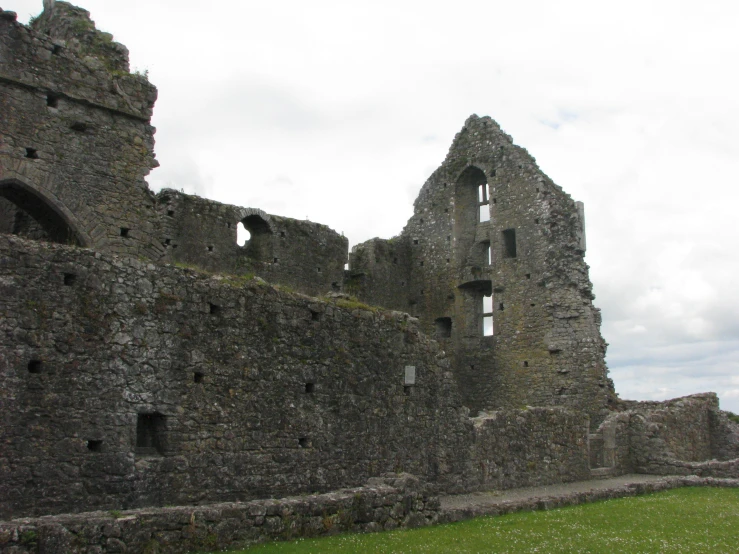 an old, destroyed stone wall with lots of windows