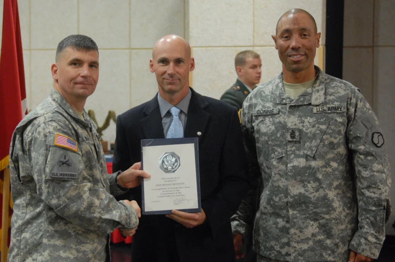 three men in military uniforms are posing for a picture