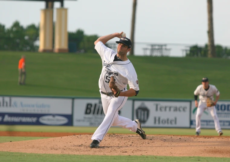 pitcher on mound, preparing to throw the ball