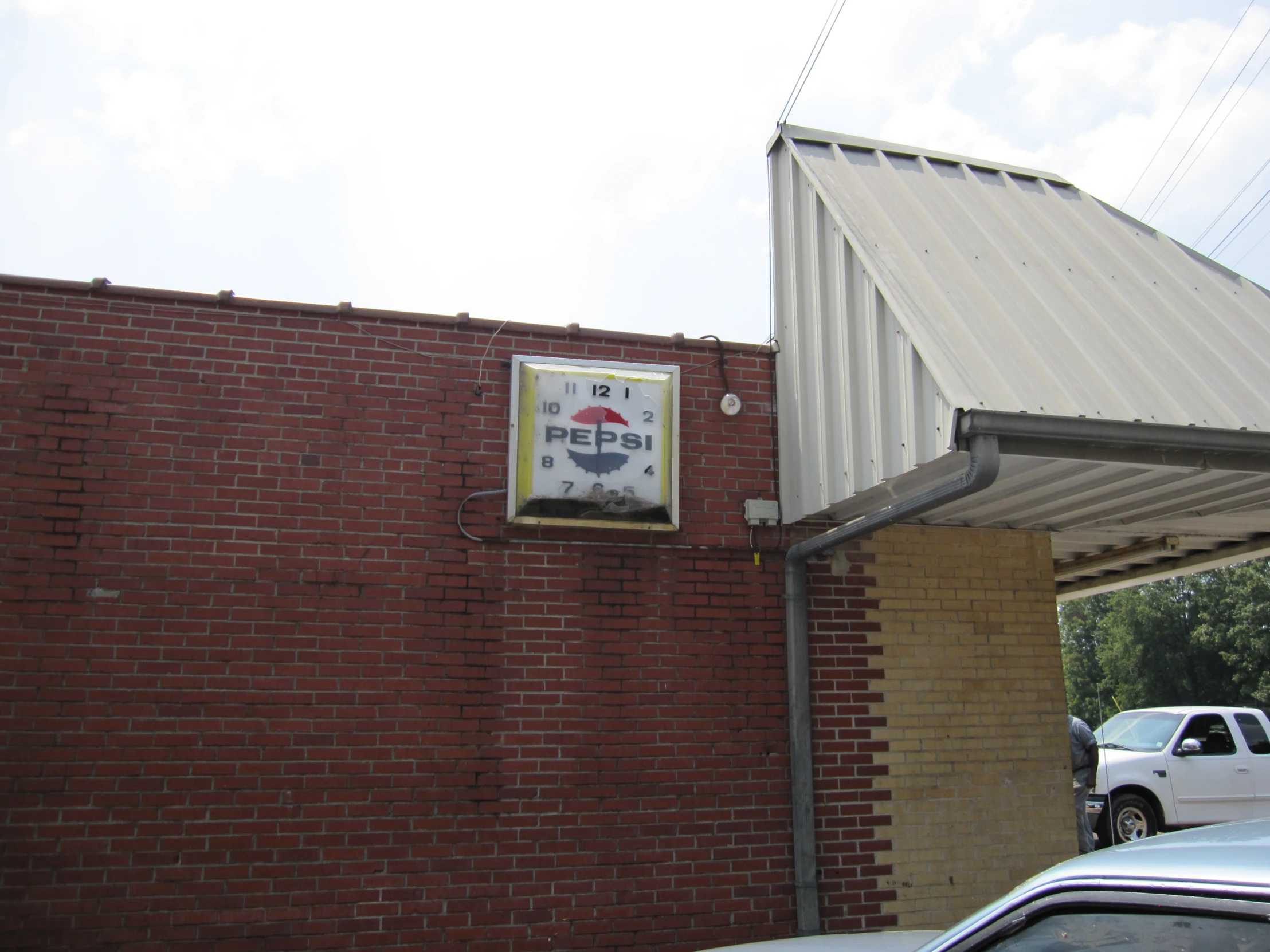 a restaurant advertit posted on a red brick wall