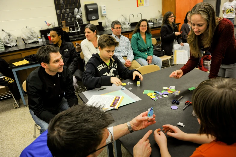 a group of people sitting around a table together