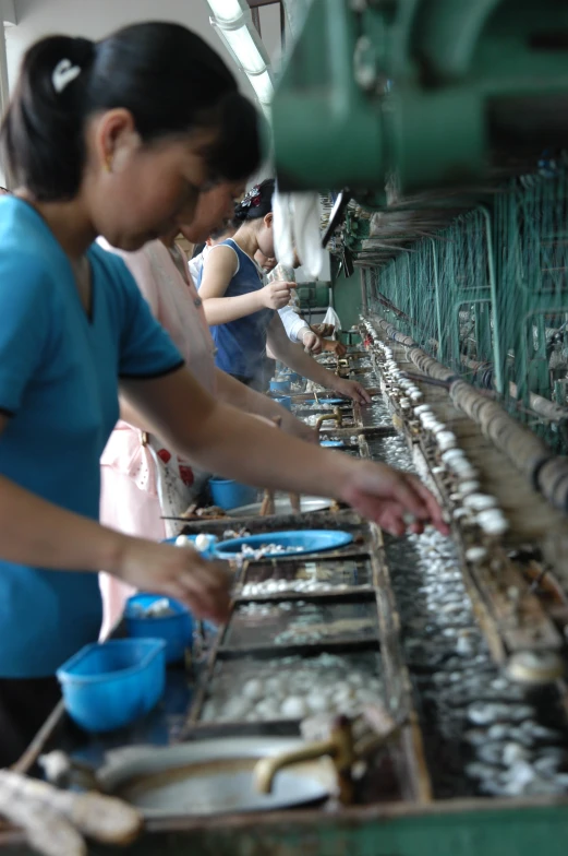 two women working at a factory line to check the items