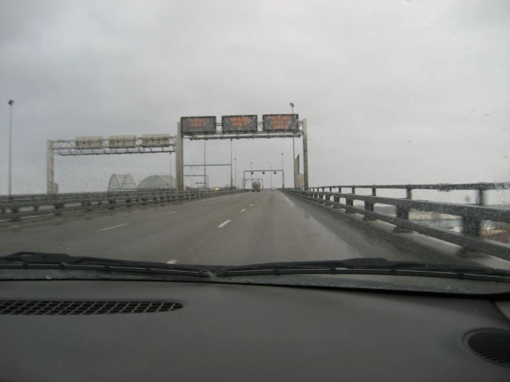 the windshield view shows an empty highway with a bunch of signs