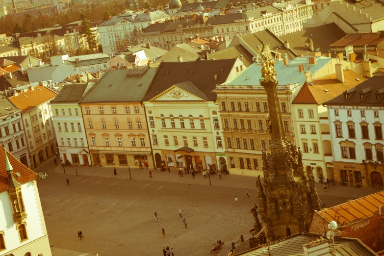 view of people, buildings and people walking around in town