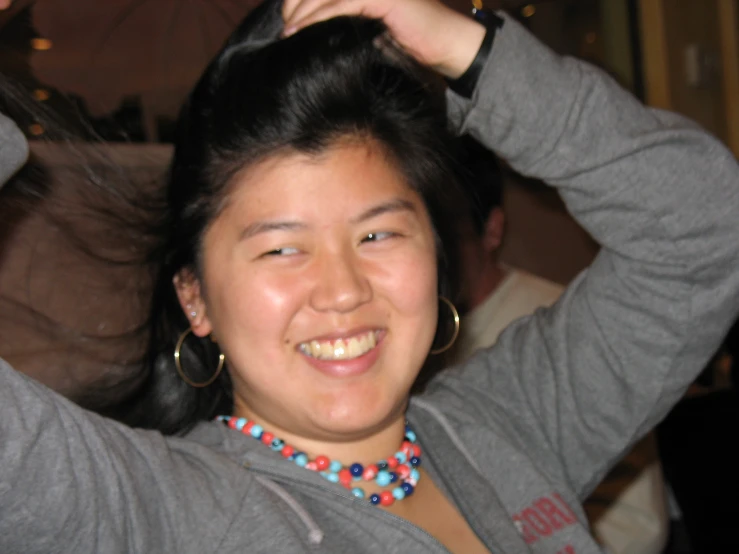 a young woman holding her hair up for the camera