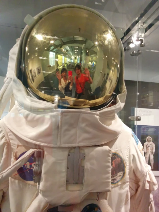 a group of young people posing in the mirror on a space suit