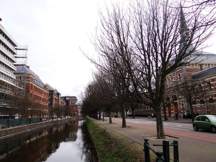 a small river running alongside the side of a city street