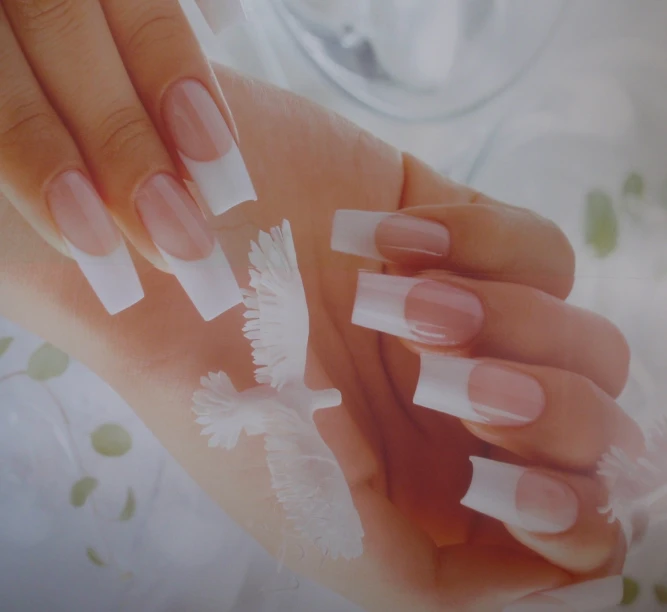 womans hands with french manies and white powder on them