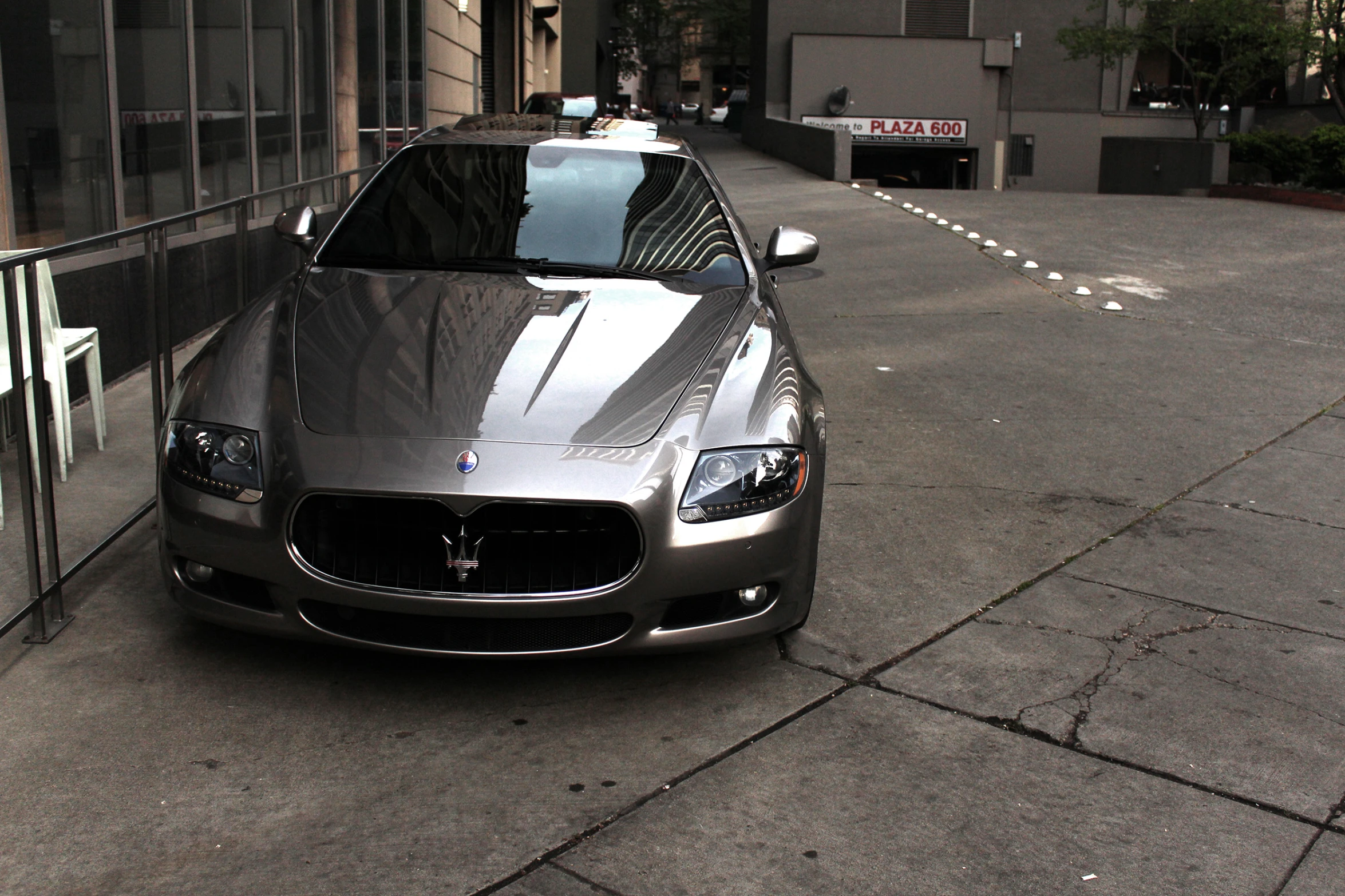 a silver sedan parked on a city street