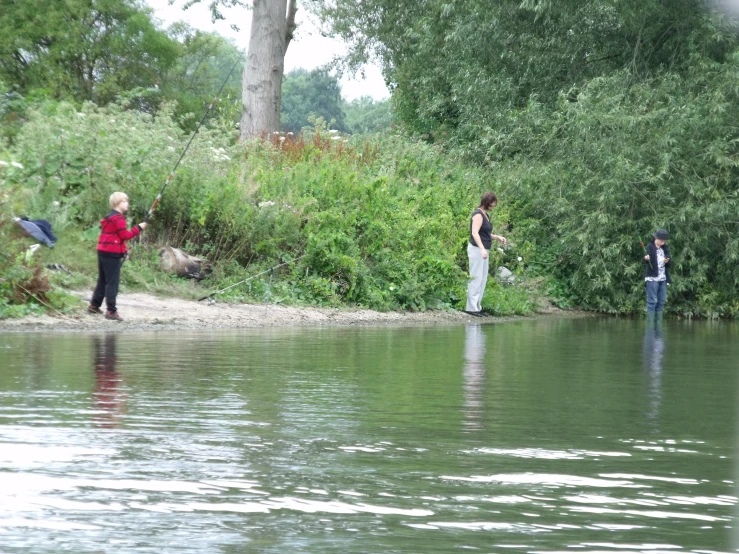 two women standing on the edge of a river