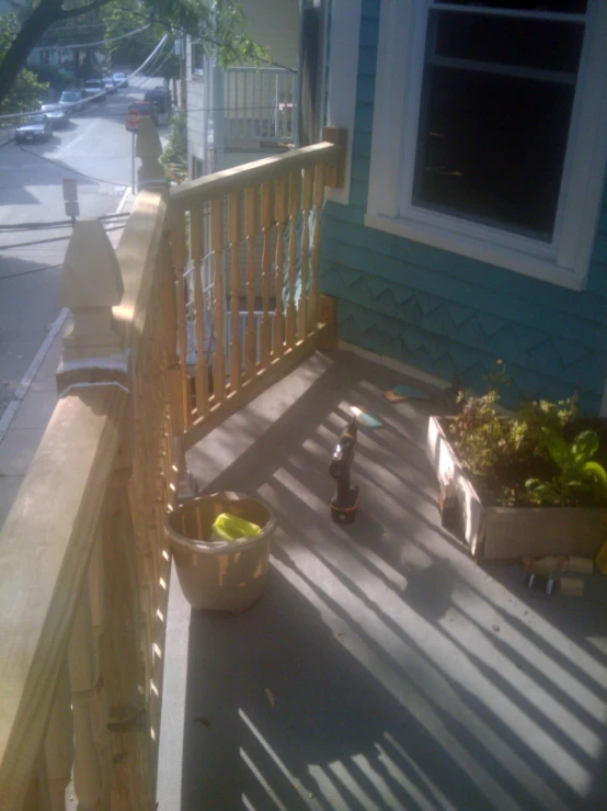 there is a bowl of fruit and an empty bowl on the porch