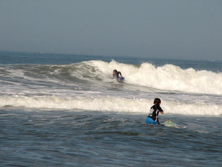 a group of people riding surfboards on top of waves