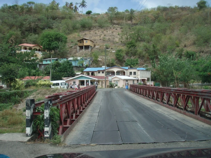 this is an image of a red bridge over a road