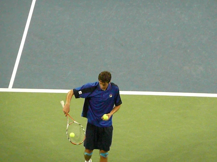 a man standing on top of a tennis court holding a racquet