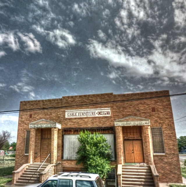 an old building with a car parked outside it