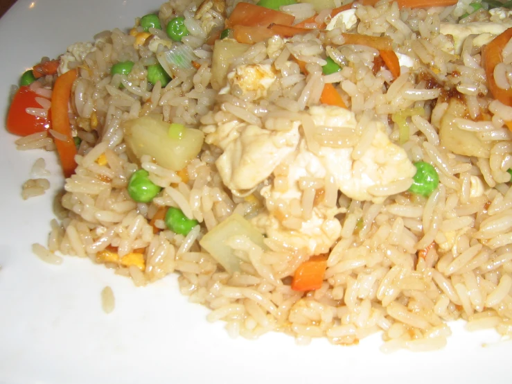 an oriental rice salad with vegetables on a white plate