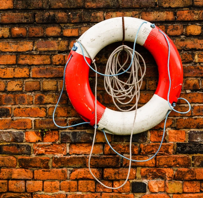 a life preserver hanging on a brick wall