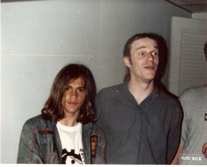 three young people with long hair and two looking away